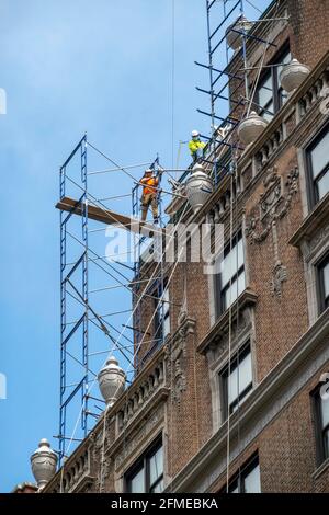 rConstruction Worker on a High-Rise Building Scaffolding, NYC, USA Stock Photo