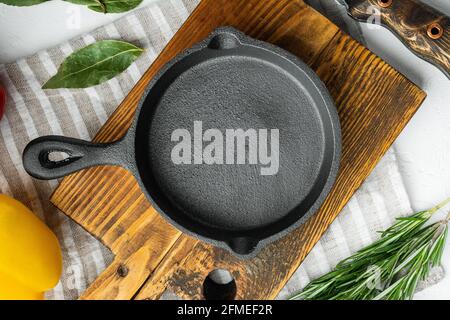 Empty frying cast iron pan background, kitchenware cooking concept, on white stone surface, top view flat lay, with copy space for text Stock Photo