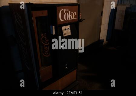 This is a photograph of an old Coke vending machine in the alleyway behind Jefferson Street in Lafayette Louisiana. Photo was taken at night. Stock Photo