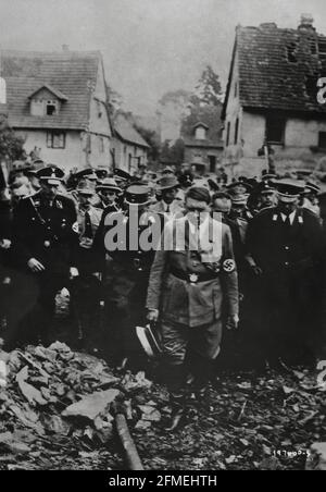 World War Two II Adolf Hitler inspects bomb damage in a German city along with his military personnel German film captured by the U.S. Army Signal Corps 1944 Stock Photo
