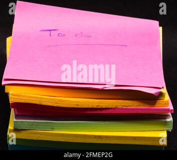 Piles of worn to do memo note pads unused after some time with a handwritten 'to do' written on the top note Stock Photo
