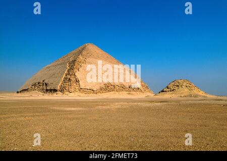 The Bent Pyramid is an ancient Egyptian pyramid located at the royal necropolis of Dahshur, approximately 40 kilometres south of Cairo. Stock Photo