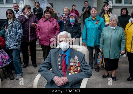 Veteran of the Second World War (Great Patriotic War) Anatoly Smetanin wearing a face mask in the courtyard of a residential building.On May 8, 2021, many veterans of the Great Patriotic War (Second World War) were congratulated in the city of Tambov. With the upcoming Victory Day holiday (May 9), the front-line soldiers were congratulated at their place of residence. Festive concerts and performances of artists were organized in the courtyards of apartment buildings. In the house 171 on the Astrakhan Street, two veterans of the Great Patriotic War were congratulated. Anatoly Smetanin and Vikt Stock Photo