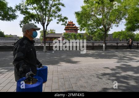 Beijing, China. 09th May, 2021. An elderly man wearing a facemask as a precaution against the spread of covid-19 seen walking along the road near the Forbidden City in Beijing. Credit: SOPA Images Limited/Alamy Live News Stock Photo