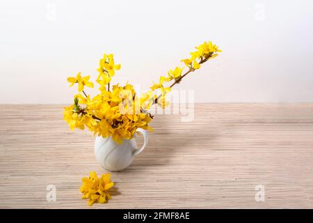 Yellow flower bouquet in vase on table with copy space Stock Photo
