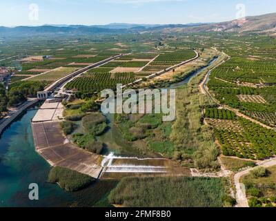 Antella weir in Jucar river (Azud de Antella) surrounded by orange-tree fields in the province of Valencia, Spain Stock Photo