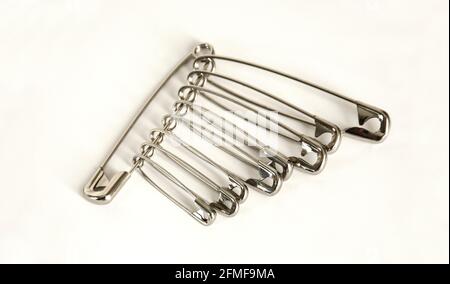 Bunch of safety pins on white background. Stock Photo