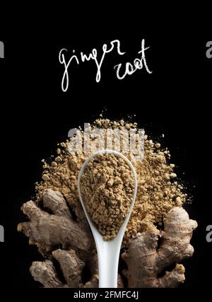 Ginger root and ground powder of ginger with handwritten inscription of chalk at black background, top view. Stock Photo