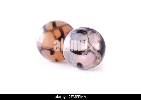 Patterned agate beads isolated on white,Round Agate beads,Semi Precious stones. Natural mineral beads. Beads made of natural stones to create jewelry. Stock Photo