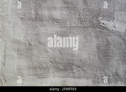 Heavily textured white and grey external plastered wall Stock Photo
