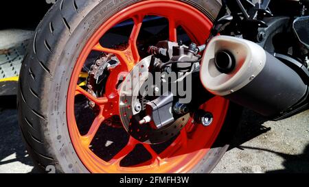 Motorcycle back wheel with a bright red rim Stock Photo