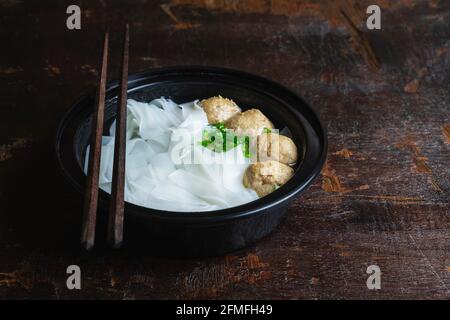 Noodles with meatballs on a wooden table Stock Photo