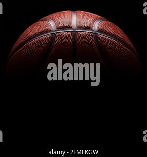 A close-up of a textured orange rubber basketball ball. Stock Photo