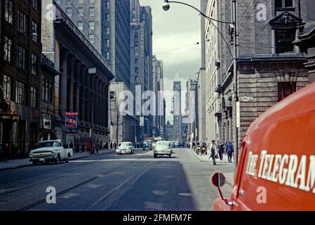 A view looking northwards along Bay Street, Toronto, Ontario, Canada c. 1957. At the top of the street is Toronto Old City Hall dating from 1899. Many of the buildings from the 1950s have been replaced but the building housing Crown Trust still stands. The lane on the right, Melinda Street, no longer exists at the Bay Street end as this area has become Commerce Court West. This image is from an old amateur Kodak 35mm colour transparency – a vintage 1950s photograph. Stock Photo