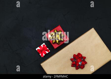 Gift boxes on a dark background. Flat lay, low key. Stock Photo