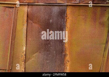 rusted tin sheets patchwork wall texture and flat detailed background Stock Photo