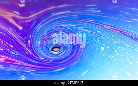 Macro of colorful iridescent flat soap surface with fluid iridescent colors and abstract patterns and shapes, futuristic space art background Stock Photo