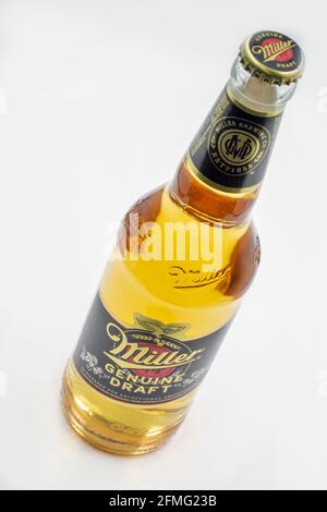 KYIV, UKRAINE - FEBRUARY 27, 2021: Miller Genuine Draft lager beer bottle closeup against white background. Miller Brewing Company is an American beer Stock Photo