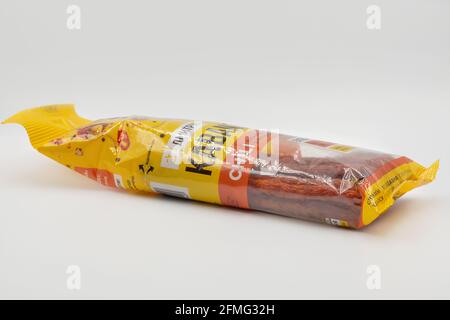 KYIV, UKRAINE - MARCH 27, 2021: Studio shot bag of Kabanosy Polish long thin dry sausage made of pork closeup against white background. Stock Photo
