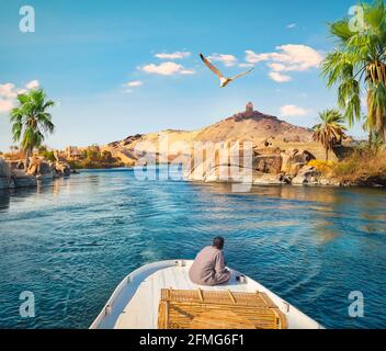 Boat driving on river Nile in Aswan, Egypt Stock Photo