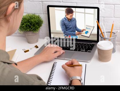 Businesswoman Watching Business Presentation Having Distant Online Meeting In Office Stock Photo