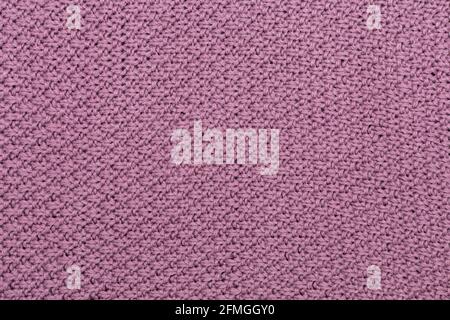 Knitted fabric pearl woolen background. The structure of the fabric with a natural texture. Fabric background. Knitted woolen background. Stock Photo