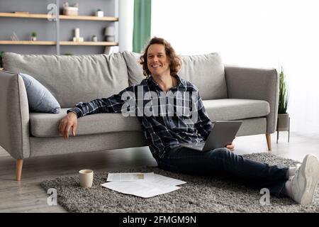 Successful Freelancer Man Posing With Laptop Working Online From Home Stock Photo