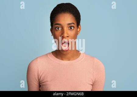 Oh No. Shocked Black Woman Looking At Camera With Opened Mouth Stock Photo