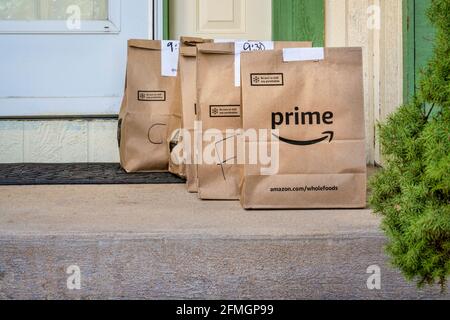 Fort Collins, CO, USA - March 31, 2020: Brown bags with groceries and fresh produce delivered to house from Whole Food Market and order through Amazon Stock Photo