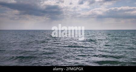 horizontal background: calm sea and sky with clouds Stock Photo