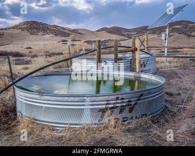 Fort Collins, CO, USA - November 23, 2020: Metal water stock tanks for cattle at Colorado foothills - Soapstone Natural Area in fall scenery. Stock Photo