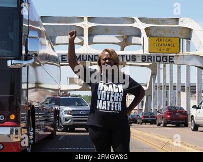 Selma, Alabama, USA. 8th May, 2021. Co-founder of Black Voters Matter LaTosha Brown stands on the Edmund Pettus Bridge as close to 400 cars travel from Selma to Montgomery to demand the restoration of legislation that protects the rights of all voters through passage of the John Lewis Voting Rights Advancement Act and the For the People Act. On March 21, 1965, Dr. Martin Luther King, Jr. led hundreds of people on foot across this bridge and on a 47 mile walk to Montgomery to demand voting rights. Credit: Sue Dorfman/ZUMA Wire/Alamy Live News Stock Photo
