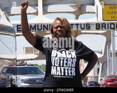 Selma, Alabama, USA. 8th May, 2021. Co-founder of Black Voters Matter LaTosha Brown stands on the Edmund Pettus Bridge as close to 400 cars travel from Selma to Montgomery to demand the restoration of legislation that protects the rights of all voters through passage of the John Lewis Voting Rights Advancement Act and the For the People Act. On March 21, 1965, Dr. Martin Luther King, Jr. led hundreds of people on foot across this bridge and on a 47 mile walk to Montgomery to demand voting rights. Credit: Sue Dorfman/ZUMA Wire/Alamy Live News Stock Photo