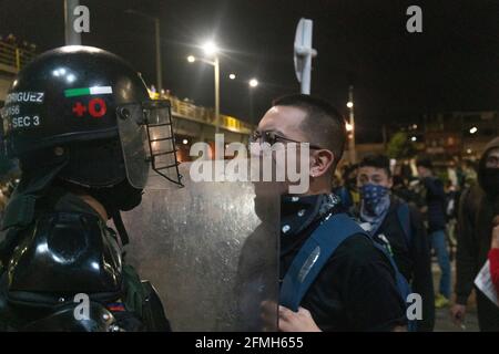 A person faces an agent of the mobile anti riot squad Stock Photo