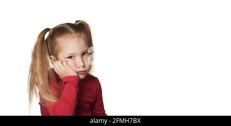 Bored baby girl portrait isolated over white background. Prop up cheek with hand. Stock Photo