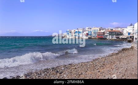 View of the famous pictorial Little Venice in Mykonos island. Splashing waves over bars and restaurants of Mykonos old town, Cyclades, Greece. Stock Photo