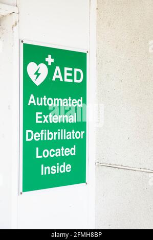 Defibrillator AED sign on wall in public space for emergency heart resuscitation Stock Photo