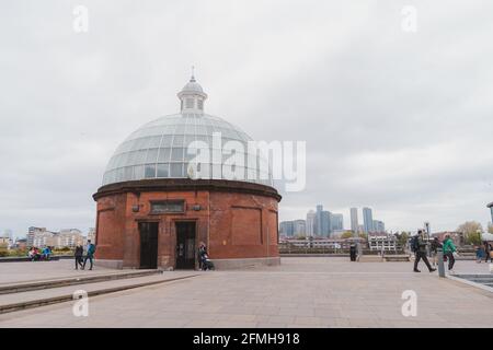 Greenwich, London | UK -  2021.05.08: The view of Greenwich foot tunnel entrance with Canary Wharf in the background Stock Photo
