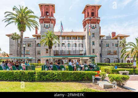 St. Augustine, USA - May 10, 2018: Flagler Lightner Museum view with tram and tour group people in Florida and architecture famous building in histori Stock Photo