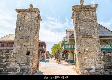 St. Augustine, USA - May 10, 2018: Saint George Street and people walking on sunny day by stores in downtown old town Florida city with stone gate ent Stock Photo