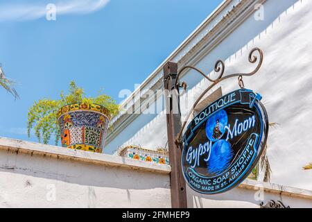 St. Augustine, USA - May 10, 2018: Saint George Street on sunny day with closeup of Gypsy Moon gift shop souvenir store in old town with flowerpot and Stock Photo