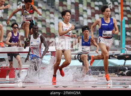 Tokyo, Japan. 9th May, 2021. Japanese athlete Ryuji Miura (R) splashes water to jump water pit en route to win men's 3000m steeplechase at a track and field meet for a test event of the Tokyo 2020 Olympic Games, while Shuhei Tada (R) finished the second and Yuki Koike (L) finished the third at the national stadium in Tokyo on Sunday, May 9, 2021. Miura won the race with the new national record of 8 minutes 17.46 seconds. Credit: Yoshio Tsunoda/AFLO/Alamy Live News Stock Photo