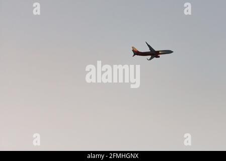 Aircraft with landing lights. The plane comes in for a landing against the darkening sky. Stock Photo