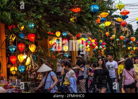 Colourful lanterns hanging between buildings in the old town, Hoi An, Vietnam Stock Photo