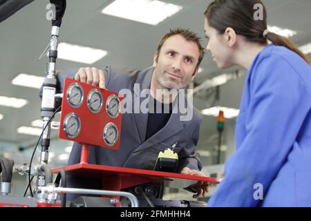 portrait of apprentice working with engineer on cnc machine Stock Photo