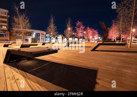 Calgary Alberta Canada, May 01 2021: Modern park benches in a public gathering area along Memorial Drive in a downtown Canadian city at night. Stock Photo