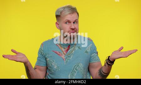 Confused handsome man feeling embarrassed about ambiguous question, having doubts, no idea, clueless Stock Photo