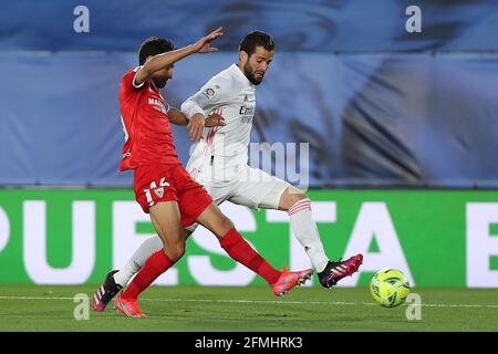Madrid, Spain. 9th May, 2021. Real Madrid's Nacho (R) vies with Sevilla's Jesus Navas during a Spanish league football match between Real Madrid and Sevilla CF in Madrid, Spain, on May 9, 2021. Credit: Edward F. Peters/Xinhua/Alamy Live News Stock Photo
