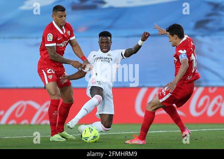 Madrid, Spain. 9th May, 2021. Real Madrid's Vinicius Jr. (C) vies with Sevilla's Jesus Navas (R) and Diego Carlos during a Spanish league football match between Real Madrid and Sevilla CF in Madrid, Spain, on May 9, 2021. Credit: Edward F. Peters/Xinhua/Alamy Live News Stock Photo