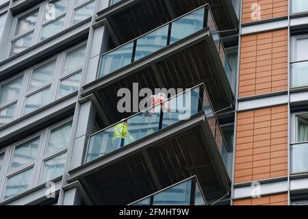 The fire service conduct safety checks after a major fire broke out at New Providence Wharf, a 19 storey high residential block in Blackwall. Stock Photo